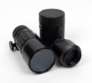 ASAHI KOGAKU: Group of two lenses - one SMC Takumar 300mm f4 [#5404862] with Takumar rear lens cap, and one SMC Takumar 135mm f2.5 [#5466816] with Asahi lens hood and Asahi lens case. (2 items)