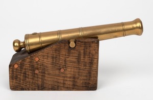 A cast brass miniature working model cannon mounted on timber block base, 20th century, the barrel 21cm long