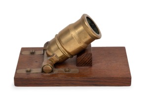 A brass working model miniature mortar on oak stand, circa 1860, 14cm long overall.