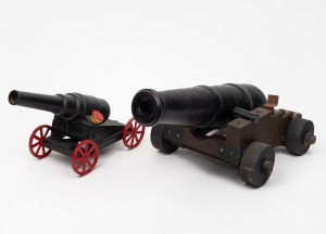 Two model cannon ornaments, one example metal and the other wood, 20th century, 45cm and 35cm long each overall