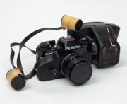 ROLLEI: Rolleiflex SL 35 ME SLR camera [#4911489], c. 1976, with Planar 50mm f1.8 lens [#1120452], together with front lens cap and leather case.
