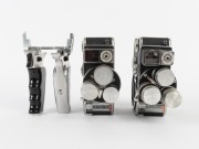 BOLEX-PAILLARD: Two c. 1958 double-8 movie cameras, both with pistol-grip attachment, wrist strap, and all lens caps present. (2 movie cameras) - 2
