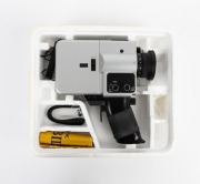 BOLEX-PAILLARD: Jubilee Super 8 movie camera, c. 1977, in maker's box with instruction booklet, remote control, and wrist strap attachment. - 2