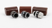 BOLEX-PAILLARD: Three lenses, each in leather case - one Pizar 5.5mm f1.9 with front and rear caps, one Yvar 13mm f1.8 with rear cap, and one Yvar 13mm f1.9 with rear cap. (3 lenses)