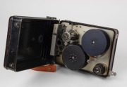 DEVRY: Circa 1926 35mm hand-cranked Devry 'Lunchbox' Standard Portable Camera, with carry strap, internally-stored Cine-Velostigmat f3.5 lens [#238841], and locking lens cap. - 2