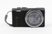 PANASONIC: Lumix DMC-TZ60 Leica digital camera [#WP4FB001455], c. 2014, with DC Vario-Elmar 6.4-129mm f6.4-4.3 lens, battery pack, and memory card. - 2