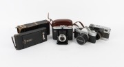 VARIOUS MANUFACTURERS: Group of four cameras - one Fujica Auto-M, one Kodak No. 1A Pocket in maker's box, one Minolta SR-1 with front lens cap, and one Zeiss Ikon Nettar 517/16 in matching leather case. (4 cameras)