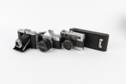VARIOUS MANUFACTURERS: Group of four cameras - one Fujica Auto-M, one Kodak No. 1A Pocket in maker's box, one Minolta SR-1 with front lens cap, and one Zeiss Ikon Nettar 517/16 in matching leather case. (4 cameras) - 2