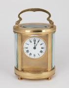An antique French oval cased time only carriage clock with Roman numeral enamel dial and gilt mask surround, the movement with original silvered lever platform escapement, circa 1900, 15cm high (handle up)