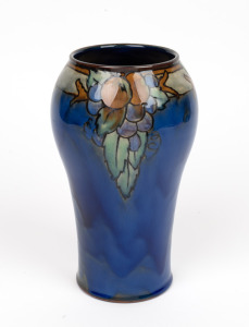 ROYAL DOULTON LAMBETH English art pottery vase with fruit decoration on blue group, early 20th century, impressed mark plus addition black ink stamp to base. ​​​​​​​22cm high.