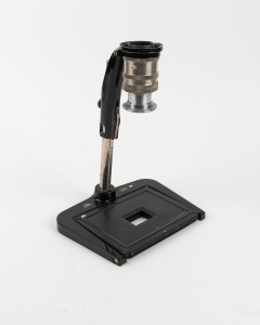 ZEISS IKON: Type 2 black and chrome close-up copy stand for Contax rangefinder cameras, c. 1936, with Tessar 50mm f3.5 lens element [#2243285], two chrome bayonet-type adaptor rings, and five metal close-up masking plates in four different aperture sizes.