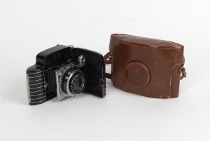 KODAK: Bantam Special folding 828 film camera [#6022952] with Ektar 45mm f2 lens [#21575], Compur-Rapid shutter, and leather case, c. 1942. Much admired for its black and silver Art Deco styling.