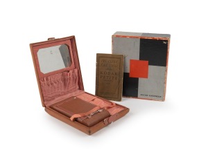 KODAK: Petite 127 film camera, in old rose with change pocket and vanity mirror, plus original 'Kodak Ensemble' maker's box and instruction booklet, c. 1931.