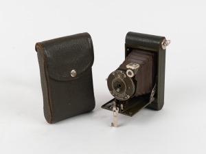 KODAK: Boy Scout Kodak 127 film camera with Boy Scout emblem engraving, original green bellows, and matching 'Be Prepared' leather case, c. 1931.