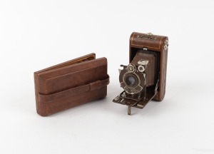 KODAK: Vest Pocket Kodak Series III Vanity 127 film camera, in brown with original bellows, Kodak Anastigmat 83mm f6.3 lens [#40935], and matching satin-lined case, c. 1930.