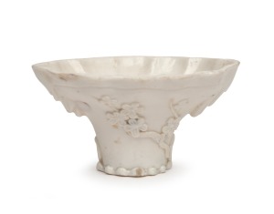 A Chinese blanc de chine porcelain libation cup, Qing Dynasty, 19th/20th century, ​​​​​​​7cm high, 13.5cm wide.