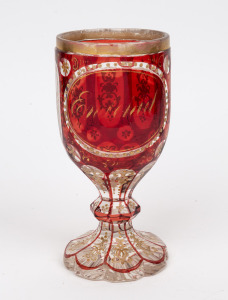 An antique Bohemian ruby overlay faceted goblet with gilt and enamel decoration, circa 1860, 19cm high.