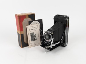 KODAK: US-Type Six-16 616 film camera with Kodak Doublet lens [#53991] and enamelled metal Art Deco faceplate, apparently mint-condition in original maker's box with instruction booklet and Kodak Pan Film advertisement, c. 1933.
