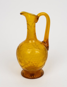 An antique Bohemian citrine glass wine ewer with wheel cut grape decoration, 19th century, 24cm high