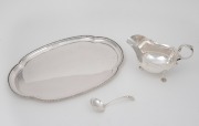 An antique sterling silver sandwich tray, sauce boat and serving ladle, early 20th century, (3 items), the tray 31.5cm wide, 640 grams total