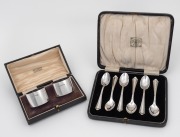 A boxed set of six English sterling silver teaspoons, Birmingham, circa 1924; together with a pair of English sterling silver napkin rings in original presentation case, by Thomas Bradbury & Sons of Sheffield, circa 1893, 190 grams total silver weight