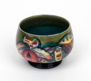 MOORCROFT "Orchid" English pottery bowl on blue and celadon green ground, impressed signature mark to base "W. Moorcroft Pottery to H. M. The Queen, Made in England", 7cm high, 9.5cm wide