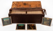 Wooden box containing eighty-one 8 x 8cm glass slides, each with colour illustration of a Christian New Testament scene, with associated Bible verse on rear.