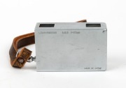 MINOLTA: Konan-16 Automat subminiature camera [#32064], c. 1950, in chrome with Rokkor 25mm f3.5 lens and wrist strap. - 3