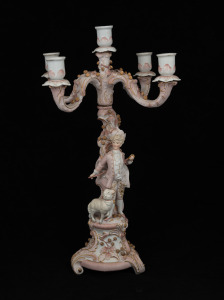 A German pink and gilt figural porcelain candelabra, early to mid 20th century, ​​​​​​​45cm high.