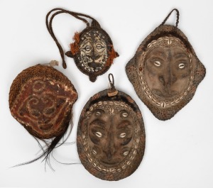 Four assorted tribal masks, tortoiseshell, fibre, feather, kauri shell and clay, Papua New Guinea origin, 20th century, ​​​​​​​the largest 29cm high