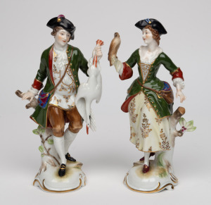 A pair of German porcelain statues of a lady and a gentleman with fowl, 20th century, the larger 20cm high