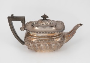 An antique English sterling silver teapot with gadrooned repousse decoration and ebonised fruitwood finial and handle, 19th century, 15cm high, 28cm wide, 640 grams including handle