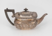 An antique English sterling silver teapot with gadrooned repousse decoration and ebonised fruitwood finial and handle, 19th century, 15cm high, 28cm wide, 640 grams including handle