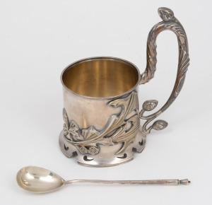 Russian silver teacup holder with gilt wash highlights and interior; together with a matching spoon, 20th century, (2 items), 13.5cm high, 243 grams total