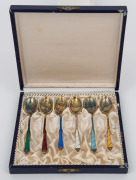 A set of six boxed Danish silver coffee spoons with gilt finished decoration and enamel highlights, 20th century