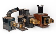 MAGIC LANTERN: A group of four medium and large-type magic lanterns, together with several loose magic lantern parts.