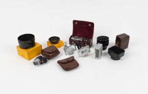 KODAK: An accumulation of twelve attachments, including 35/80 viewfinder with leather pouch, seven lens hoods, Kodalux light meter, and others. (12 items)