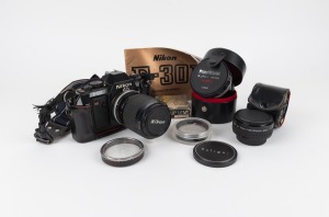 NIPPON KOGAKU: Nikon F-301 SLR camera with Nikon 35-105mm lens, instruction booklet, and other accessories, c. 1985.
