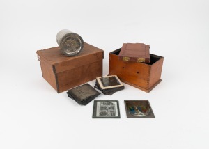 Fourteen 8 x 8cm glass slides, together with field camera plate holder and metal Kodak film tank, c. 1900s.