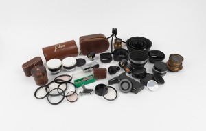 VARIOUS MANUFACTURERS: Remainder lot of more than thirty camera accessories from various minor manufacturers, including lens hoods, viewfinders, two brass lenses, and front and rear lens caps. (30+ items)