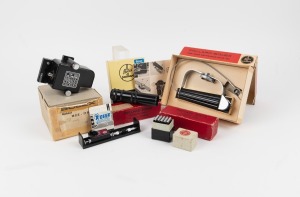 BOLEX-PAILLARD: Group of eight movie camera accessories, all in maker's boxes, including one self-timer, one shutter release cable, two extension tube sets, one electric motor, one 'static' handle, and others. (8 items)