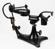 An antique ophthalmoscope with original black finish and patent plaque, 19th century, ​​​​​​​40cm high, 54cm wide