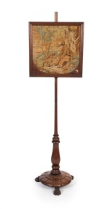 An antique English mahogany pole screen with claw feet, carved platform base, turned column and tapestry top, 19th century. Note: Missing finial. 135cm high