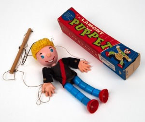 A small puppet made in Melbourne by Lamont Puppets, circa 1960, dressed in ESSENDON colours and resting in the original box (lacking lid) of purchase. Accompanied by an article by Rick Milne in which he comments on the extreme rarity of this particular do
