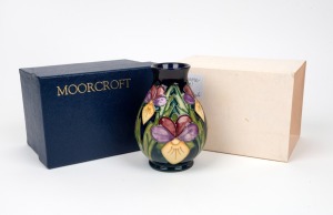 MOORCROFT "Heartsease" English baluster shaped pottery vase on dark blue and green ground, in original box of issue, circa 1994, impressed factory mark and artist details to base, 14cm high