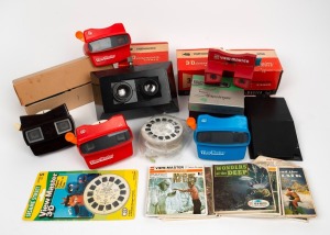 VIEW-MASTER: Group of nine stereoscopes (four Bakelite and five plastic), together with more than one hundred and sixty View-Master reels, including such titles as Lost in Space, Lady and the Tramp, The Love Bug, and Land of the Lost, plus one unidentifie