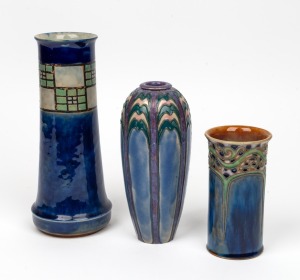 ROYAL DOULTON group of three English pottery stoneware vases with Arts & Crafts decoration on blue ground, impressed factory marks to base, the largest 25.5cm high
