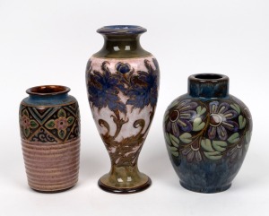 ROYAL DOULTON group of three English pottery stoneware vases with floral decoration on blue, pink and green grounds, impressed factory marks to base, the largest 28cm high