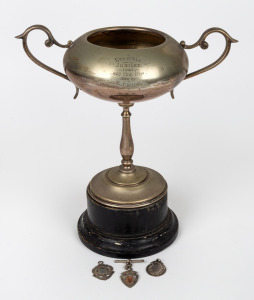 STAWELL GIFT RUNNING RACE: Trophy, likely EPNS, inscribed 'Stawell Jubilee 1927 - 400 Yds Hcp - Won by E.J. Ride (Edwin James Ride)', height 28cm including plinth, plus three small c. 1918 sterling silver race medallions, the three of them 18 grams total. The Stawell Gift, dating back to 1878, is known for its unusual handicapping system. (4 items)