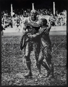 NORM PROVAN and ARTHUR SUMMONS, original signatures on a large format print of the iconic photograph by John O'Gready, known as "The Gladiators"; overall 43 x 34cm.